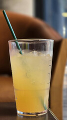 Wall Mural - Refreshing iced drink in clear cup with green straw
