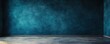 © Akash - Soft blurred background of an empty room with blue walls and concrete flooring