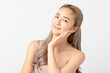 © Shutter B - Happy beautiful young asian woman smile touching her face on white background, clean fresh bare skin concept. Facial treatment, Perfect skin, Natural make up.
