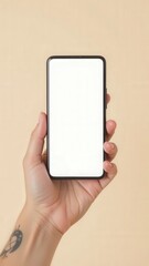 Poster - Woman hand with tattoo holding modern smartphone with blank white screen on beige background