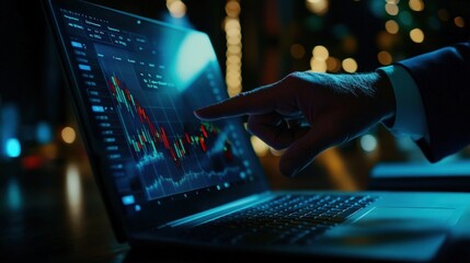 Poster - Close-up of a hand interacting with financial data on a laptop screen at night.