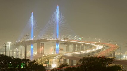 Wall Mural - A nighttime timelapse of Long Beach International Gateway Bridge with moving lights