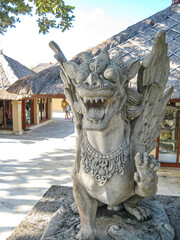 Traditional demon guards statue carved in stone in Bali island. Kuta Bali Indonesia Gardian statue at entrance Bali temple / Bali Hindu temple / Bali, Indonesia