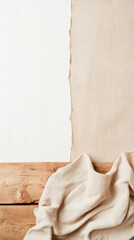 Poster - Neutral toned fabric draped on wooden surface with textured beige and white background