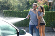 © PheelingsMedia - Happy couple washing car at home