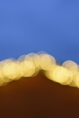 Wall Mural - golden yellow bokeh balls shining bright in the evening sky.