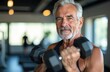 © YULIA - Elderly fit man with gray hair doing sports in the fitness center. Movement is life. Support for health and longevity. Healthy active lifestyle at any age. High quality photo