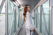 © Kzenon - Businesswoman boarding plane walking in the bridge connecting the airport gate and the plane