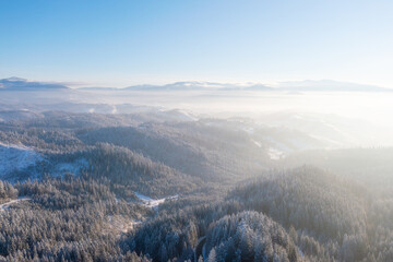 Wall Mural - mountain valley. scene from drone. forest covered in snow. natural winter landscape from air. landsc