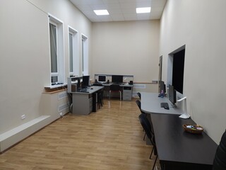 Interior of a modern office with white walls and wooden floor. Nobody inside