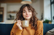 © Alienmonster Images - A Cozy Lifestyle Portrait of a Woman Enjoying a Warm Beverage in a Relaxed and Inviting Home Setting