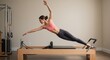 © Talha  - Woman Doing Pilates Reformer Exercise in Studio