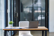 © David - Laptop Computer, notebook, and eyeglasses sitting on a desk in a large open plan office space after working hours