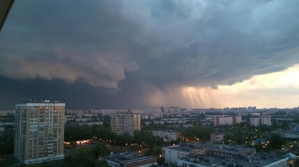 Aufkleber - A dramatic sky filled with dark clouds and rain over a city landscape at dusk.