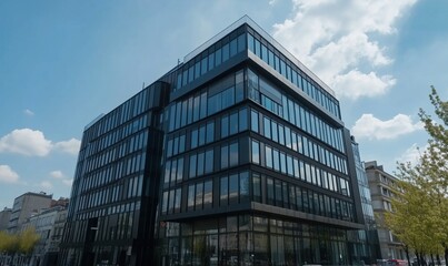 Poster - Modern architectural design of sleek glass office building with angular facade and blue sky backdrop