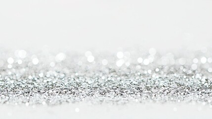 Poster - a close-up of a white background with silver glitter on it, appearing both at the bottom of the imag