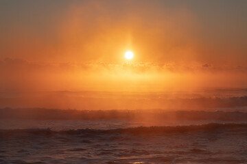 Wall Mural - Vibrant Ocean Sunrise with Golden Sky and Rolling Waves