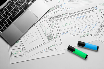 Leinwandbilder - Developing UI design. Sketches of website wireframes, laptop and felt pens on white marble table, top view