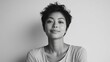 © Lion - Young Asian woman in her 20s, short hair, wearing a casual t shirt, smiling softly, neutral background