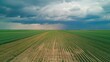 © Kitta Studio - Expansive Agricultural Field Under Dramatic Stormy Sky with Lightning