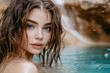 © Atlantis - Jeune femme aux yeux bleu devant une cascade