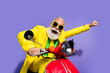 © deagreez - Photo of eccentric crazy pensioner wearing yellow trendy costume riding vacation motorcycle isolated on purple color background
