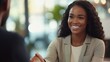 © KHF - A smiling businesswoman manager shaking hands with a client during an office meeting, demonstrating professionalism and mutual agreement.