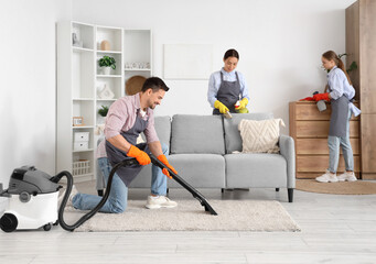 Wall Mural - Team of young janitors cleaning in room