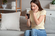 © Pixel-Shot - Young woman suffering from toothache with soda on sofa at home
