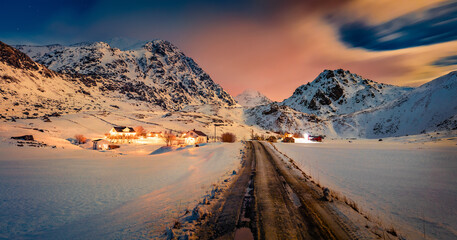 Wall Mural - gorgeous winter scene on lofoten islands. illuminated night view of utakleiv village with dirty coun