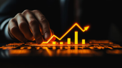 Wall Mural - Man is pointing at a graph on a computer screen. The graph shows a steep upward trend, which could represent a company's stock price or some other financial data