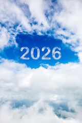 Wall Mural - Sky cloud year 2026. Happy New year concept. 2026 cloud against the blue sky.Year 2020 symbol inscription on a background of blue sky from white smoke of clouds lit by a bright sun