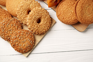 Wall Mural - Assorted baked cookies arranged on a wooden platter with a light background