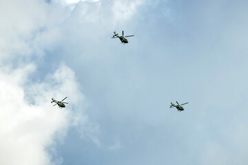 helicopters are are flying as a formation on isolatwd overcast mid-air sky
