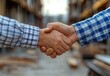 © Gayan - Two Hands Shake Over a Construction Site