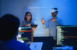 © weedezign - developer uses a VR headset to interact with projected interface designs, while colleagues discuss and code on screens, highlighting the integration of virtual reality and UI/UX design