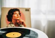 © Anna - Vintage music vibes with vinyl record and retro album cover in sunlit room. Concept of nostalgia and love for music