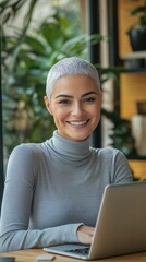 Poster - Smiling woman in grey turtleneck works on laptop in vibrant minimalist workspace filled with greenery
