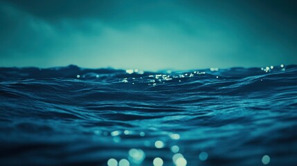 Poster - Bokeh effects create a stunning aqua and indigo ambiance over the tranquil ocean waves at dusk