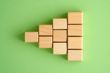 Poster - Wooden blocks arranged in a creative pattern on a vibrant green background, symbolizing structure and design.