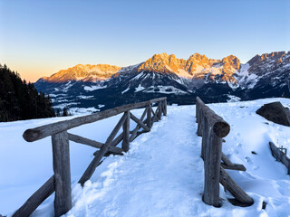 Wall Mural - Alpenglow at the Wilder Kaiser with wooden bridge, Going, Tyrol, Austria