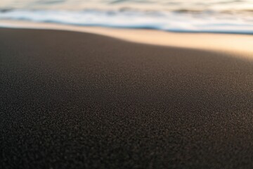 Poster - Fine black sand glistens under soft light beside gentle ocean waves, creating a serene atmosphere that exudes mystery and elegance in nature
