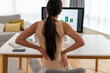 © NDABCREATIVITY - Tired woman worker sit at desk touch back suffer, woman strong backache, incorrect posture concept