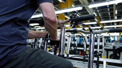 Aufkleber - Manufacturing process of electric scooters in a factory setting with workers and equipment
