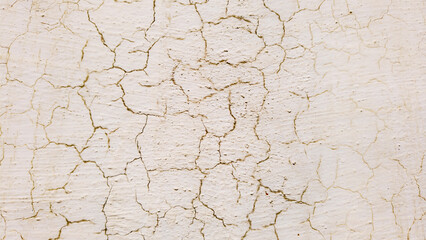 Cracked white paint on the wall. Abstract background and texture for design.