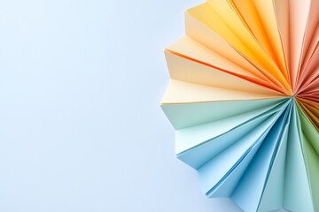 Poster - Single flower made from folded pastel paper rests on a smooth white surface, showcasing subtle shadows and ample copy space for creative use
