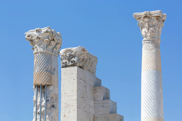 Wall Mural - Ancient columns with detailed capitals in Laodicea, showcasing ornate carvings, spiral fluting, and a bright blue sky background. Denizli, Turkey (Turliye)