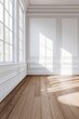 © grey - A white room with a brown wooden floor, white walls, and a window on the left side.
