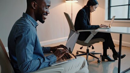 Poster - Collaborative work environment in a modern office featuring focused individuals at their computers