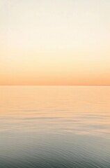 a calm ocean with a beautiful orange sky in the background